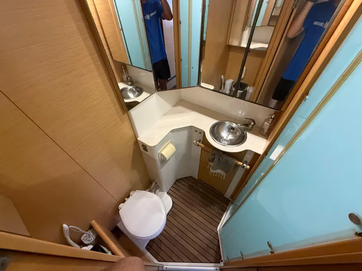 Carolina Breeze Yacht Photos Pics Compact bathroom in a 2009 Lagoon 500 yacht with modern fixtures and wooden flooring.