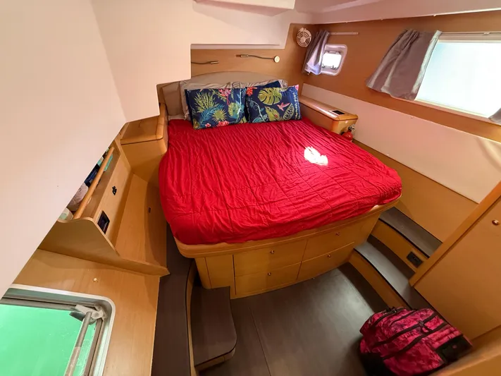 Carolina Breeze Yacht Photos Pics Luxurious cabin interior of 2009 Lagoon 500 yacht with red bedding and wooden furnishings.