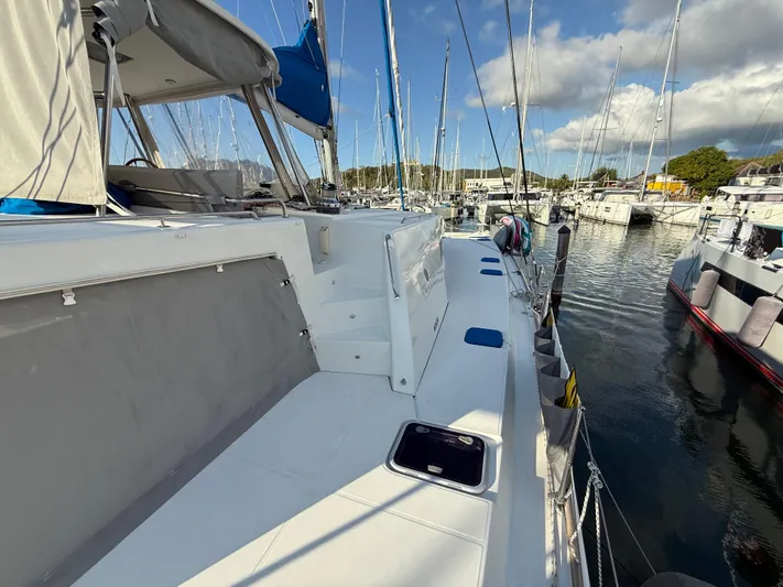 Carolina Breeze Yacht Photos Pics Lagoon 500 catamaran, 2009 model, docked in a marina under a partly cloudy sky.