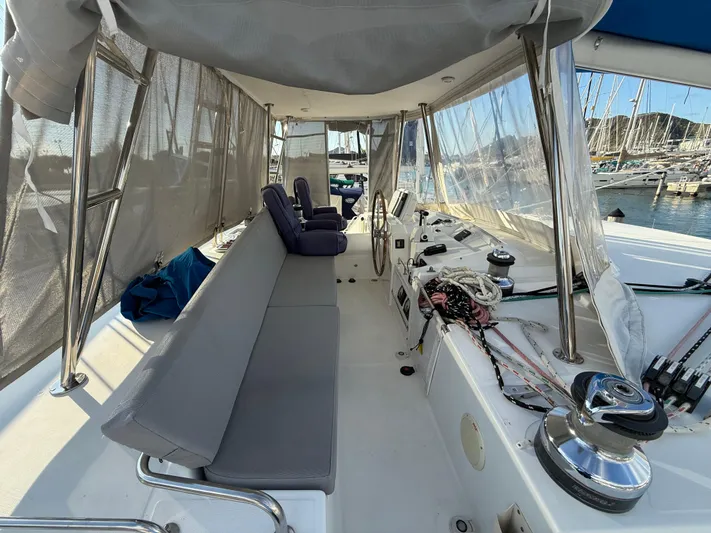 Carolina Breeze Yacht Photos Pics 2009 Lagoon 500 yacht cockpit with seating, helm, and marina view.