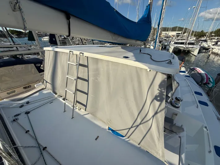 Carolina Breeze Yacht Photos Pics 2009 Lagoon 500 yacht with covered deck and ladder in a marina setting.