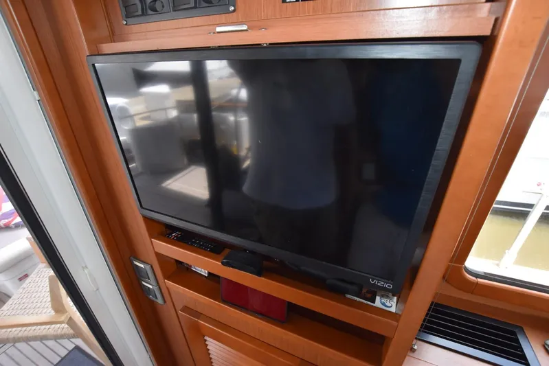  Yacht Photos Pics Flat-screen TV in 2019 Beneteau Swift Trawler 44 interior, wooden paneling.