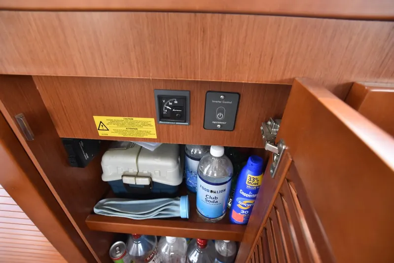  Yacht Photos Pics Cabinet interior on 2019 Beneteau Swift Trawler 44 with inverter control and storage items.