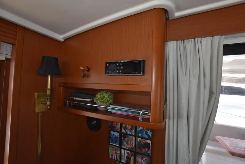  Yacht Photos Pics Interior of 2019 Beneteau Swift Trawler 44 with wooden shelves and decor.