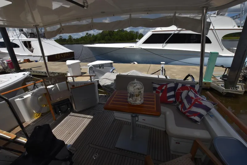  Yacht Photos Pics 2019 Beneteau Swift Trawler 44 interior with seating, table, and nautical decor at dock.
