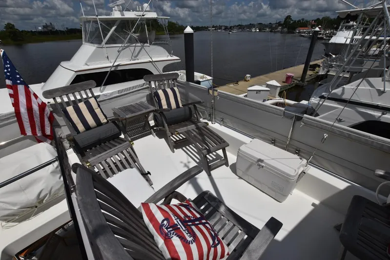  Yacht Photos Pics 2019 Beneteau Swift Trawler 44 deck with chairs, cooler, and American flag.