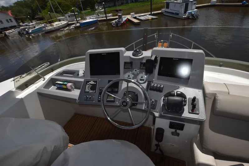  Yacht Photos Pics Helm of 2019 Beneteau Swift Trawler 44 with navigation equipment and controls, docked by the water.