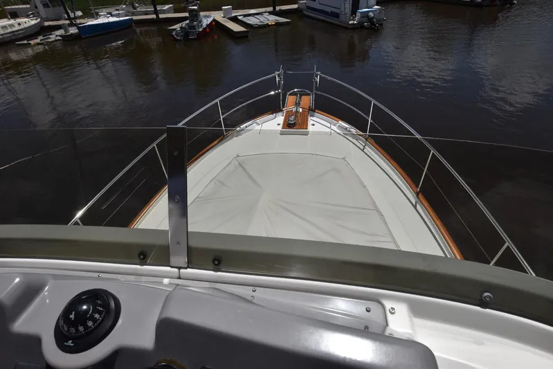  Yacht Photos Pics 2019 Beneteau Swift Trawler 44 bow view, docked in a marina.