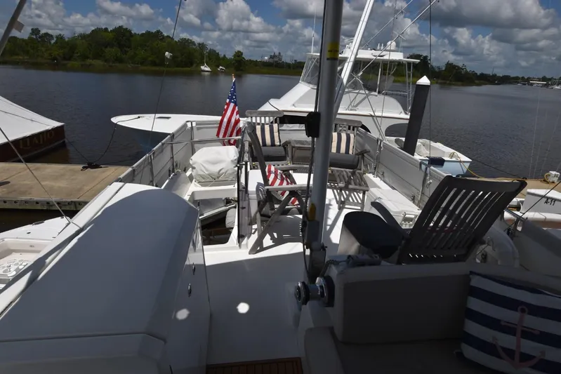  Yacht Photos Pics 2019 Beneteau Swift Trawler 44 docked, featuring spacious deck with chairs and American flags.