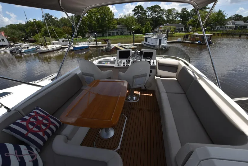  Yacht Photos Pics Flybridge of 2019 Beneteau Swift Trawler 44 with seating, table, and helm station.