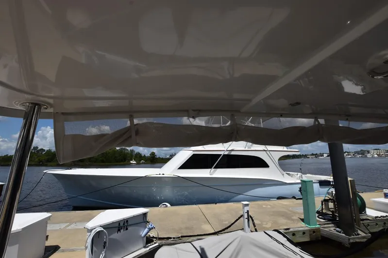  Yacht Photos Pics 2019 Beneteau Swift Trawler 44 docked at marina, viewed from under canopy.