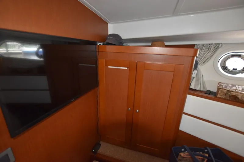  Yacht Photos Pics Interior of 2019 Beneteau Swift Trawler 44 with TV and wooden cabinet.