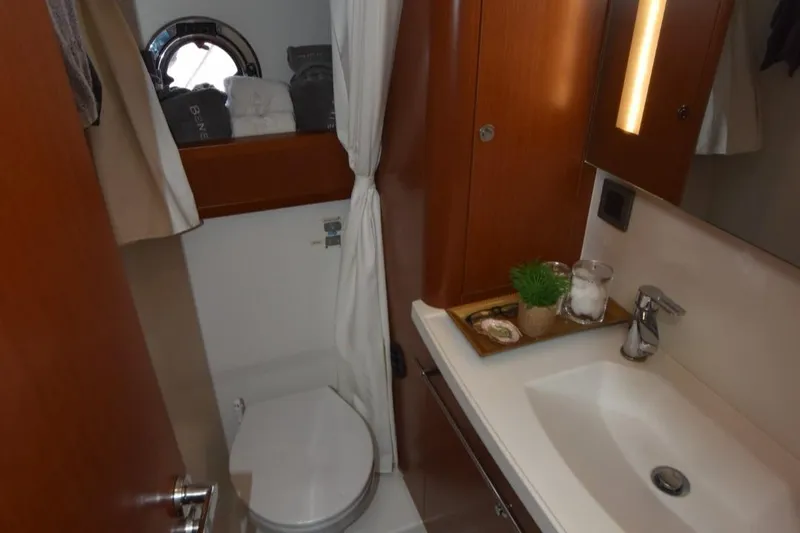  Yacht Photos Pics Bathroom interior of 2019 Beneteau Swift Trawler 44 with sink and toilet.