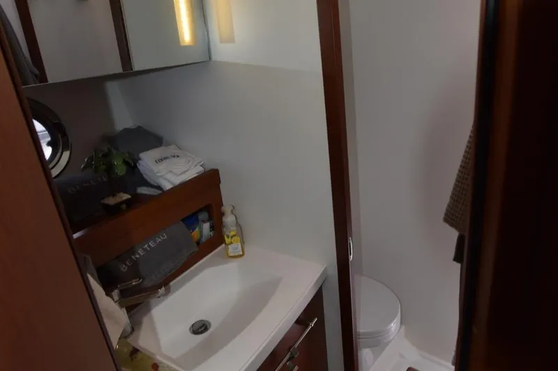  Yacht Photos Pics Bathroom interior of 2019 Beneteau Swift Trawler 44, featuring sink and toilet.