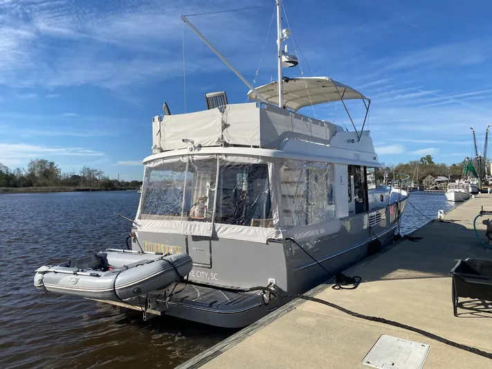  Yacht Photos Pics 2019 Beneteau Swift Trawler 44 docked, featuring a small inflatable boat.