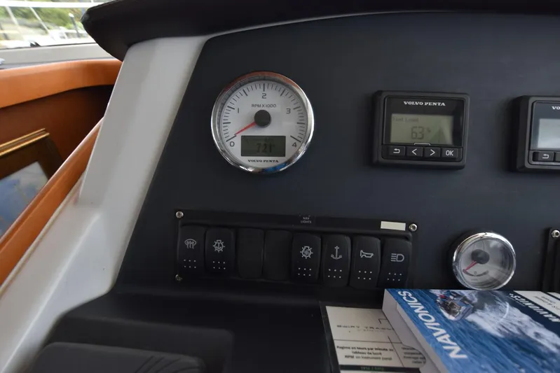  Yacht Photos Pics Control panel of a 2019 Beneteau Swift Trawler 44 with gauges and Navionics book.