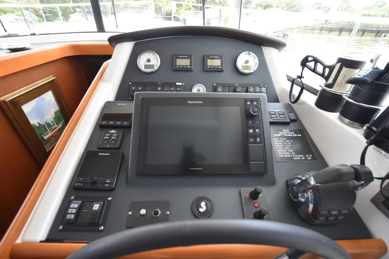  Yacht Photos Pics Helm station of 2019 Beneteau Swift Trawler 44 with navigation equipment and controls.