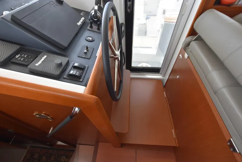  Yacht Photos Pics Helm station of 2019 Beneteau Swift Trawler 44 with Raymarine controls and wooden finish.