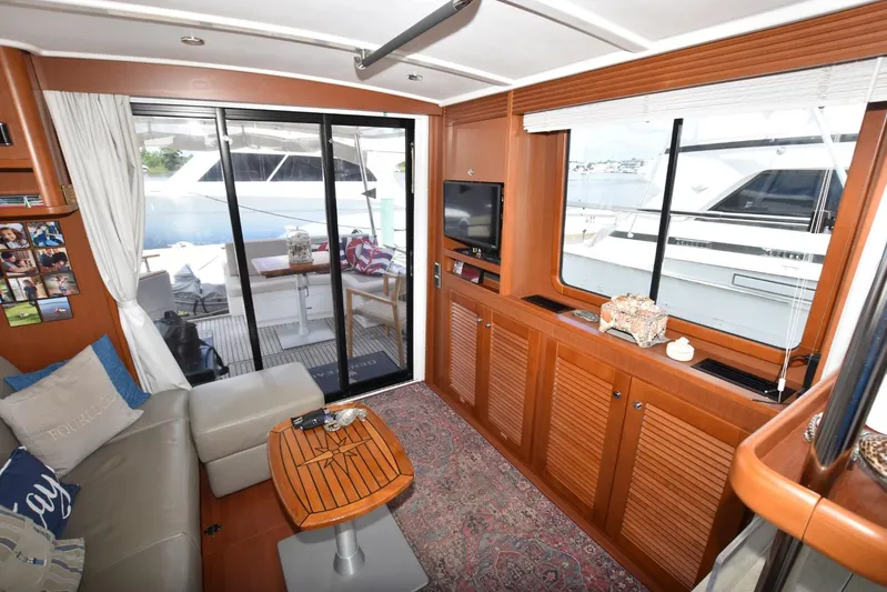  Yacht Photos Pics Interior of 2019 Beneteau Swift Trawler 44, featuring cozy seating and elegant wood finishes.