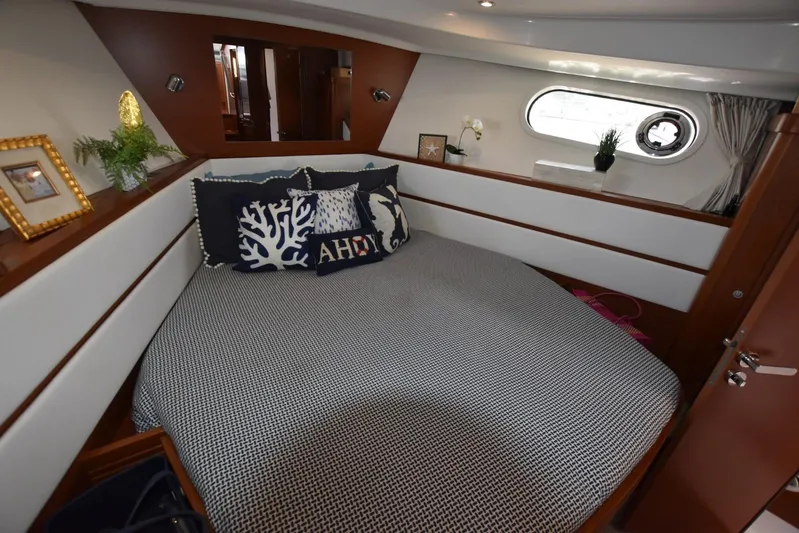  Yacht Photos Pics Cozy bedroom in 2019 Beneteau Swift Trawler 44 with nautical decor and porthole window.