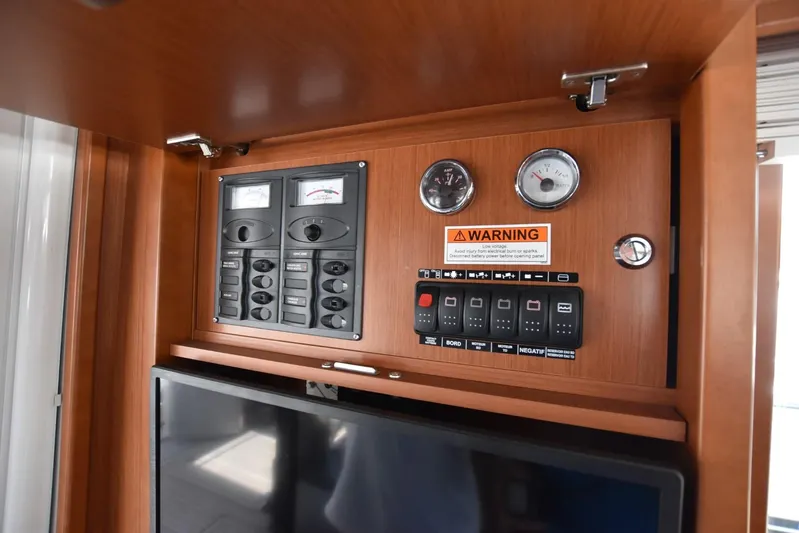  Yacht Photos Pics Control panel on 2019 Beneteau Swift Trawler 44, featuring gauges and warning label.