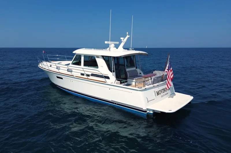 Moving On Yacht Photos Pics 2022 Sabre 48 Salon Express yacht on open sea, featuring sleek design and American flag.