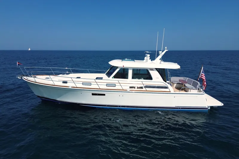 Moving On Yacht Photos Pics 2022 Sabre 48 Salon Express yacht cruising on open sea under clear blue sky.