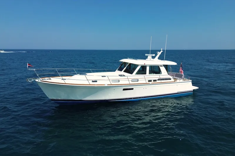 Moving On Yacht Photos Pics 2022 Sabre 48 Salon Express yacht cruising on open sea under clear blue sky.