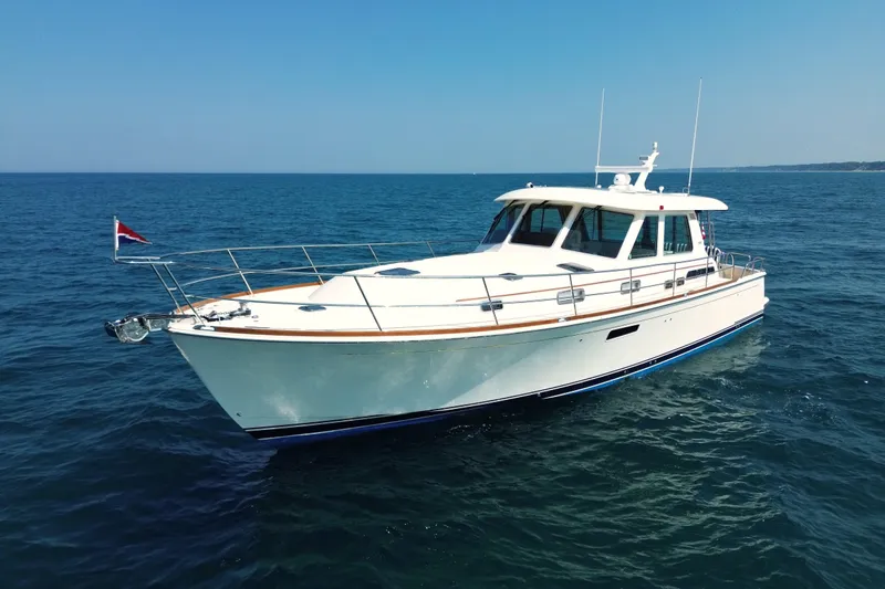 Moving On Yacht Photos Pics 2022 Sabre 48 Salon Express yacht cruising on open sea under clear blue sky.