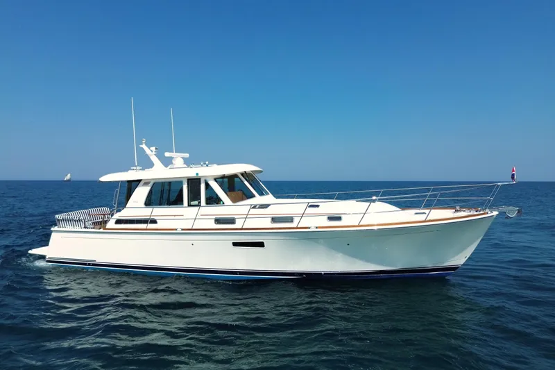 Moving On Yacht Photos Pics 2022 Sabre 48 Salon Express yacht cruising on open sea under clear blue sky.