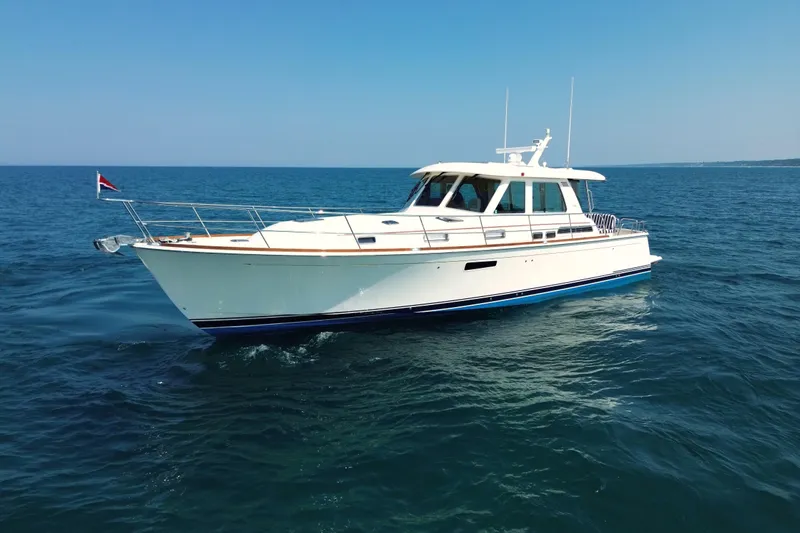 Moving On Yacht Photos Pics 2022 Sabre 48 Salon Express yacht cruising on open sea under clear blue sky.