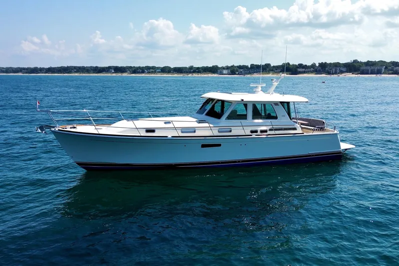 Moving On Yacht Photos Pics 2022 Sabre 48 Salon Express yacht cruising on a sunny day in open waters.