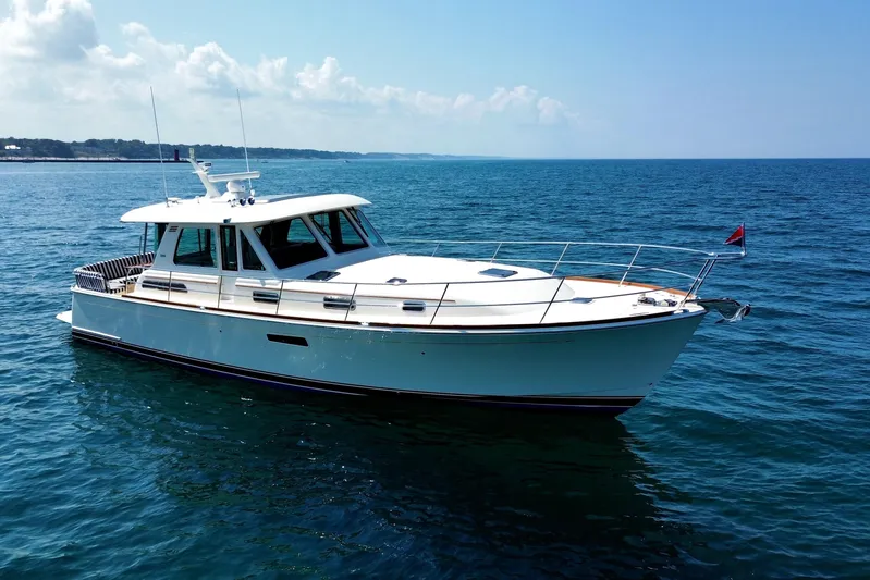 Moving On Yacht Photos Pics 2022 Sabre 48 Salon Express yacht cruising on open water under clear skies.