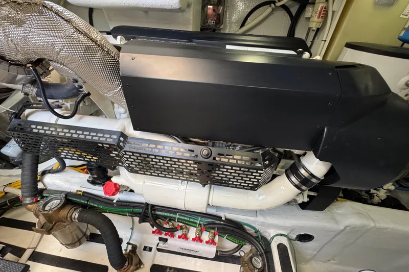 Moving On Yacht Photos Pics Engine room of 2022 Sabre 48 Salon Express yacht, showcasing mechanical components and piping.