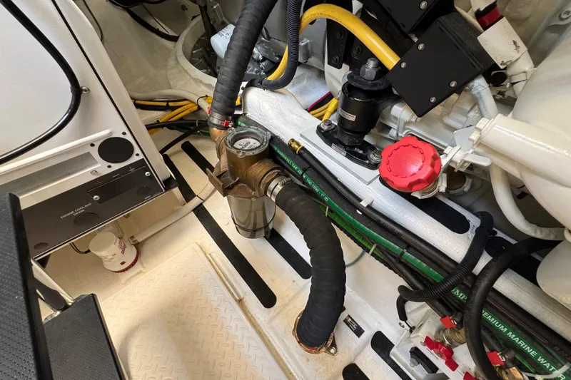 Moving On Yacht Photos Pics Engine room of 2022 Sabre 48 Salon Express, showcasing mechanical components and hoses.