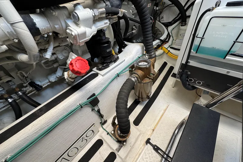 Moving On Yacht Photos Pics Engine room of 2022 Sabre 48 Salon Express, showcasing mechanical components and piping.