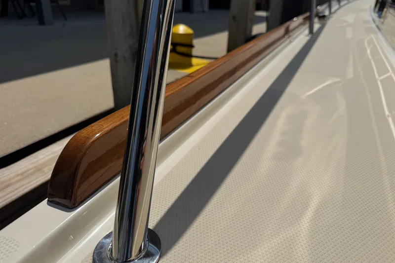 Moving On Yacht Photos Pics 2022 Sabre 48 Salon Express yacht deck with polished railing and wooden trim.