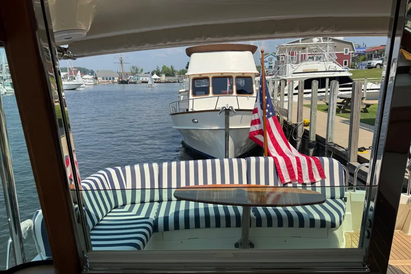 Moving On Yacht Photos Pics 2022 Sabre 48 Salon Express yacht interior with striped seating and American flag.