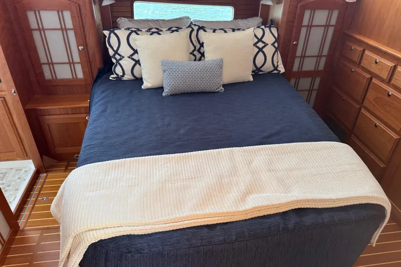 Moving On Yacht Photos Pics Luxurious bedroom interior of 2022 Sabre 48 Salon Express yacht with elegant bedding.