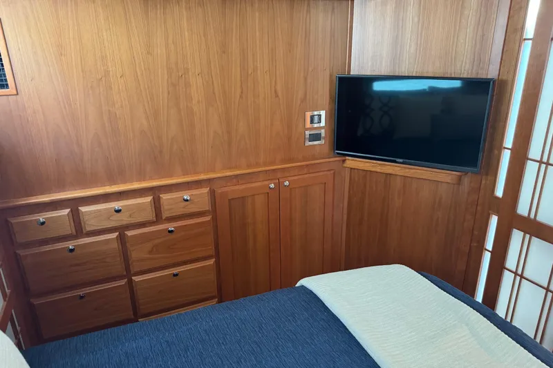 Moving On Yacht Photos Pics Interior of 2022 Sabre 48 Salon Express with wood cabinetry and mounted TV.