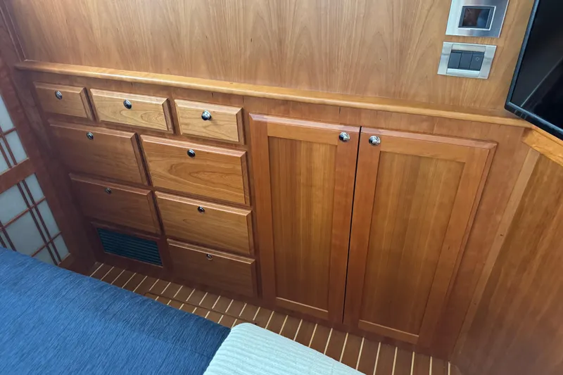 Moving On Yacht Photos Pics Wooden cabinetry in 2022 Sabre 48 Salon Express yacht interior, featuring drawers and paneling.