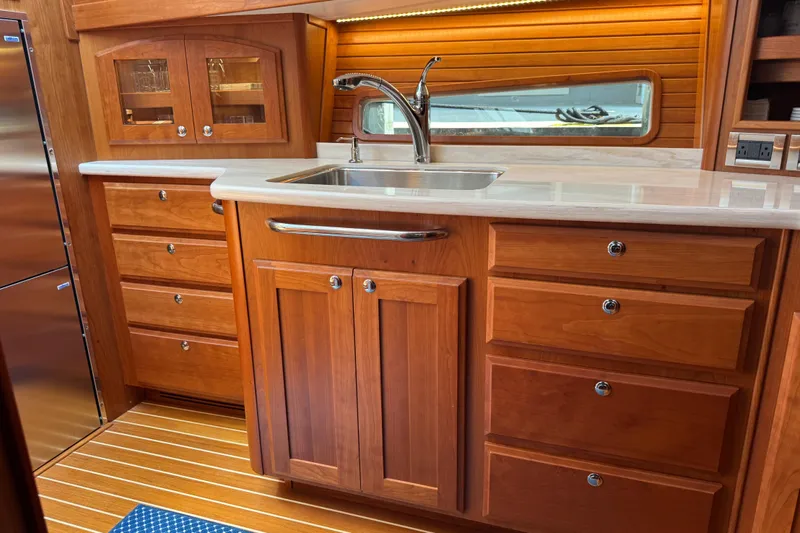 Moving On Yacht Photos Pics Luxurious wooden kitchen interior of 2022 Sabre 48 Salon Express yacht.