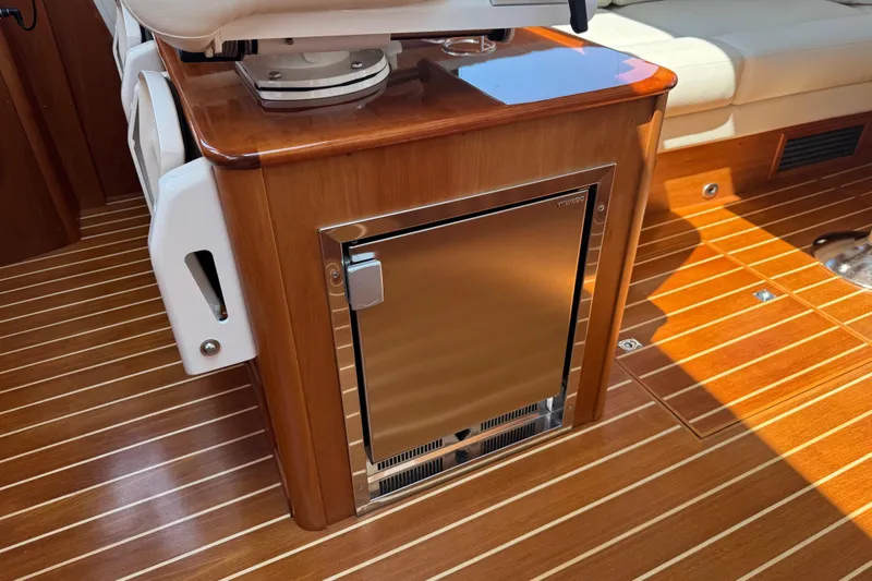 Moving On Yacht Photos Pics Luxurious interior of 2022 Sabre 48 Salon Express with wood finish and built-in fridge.