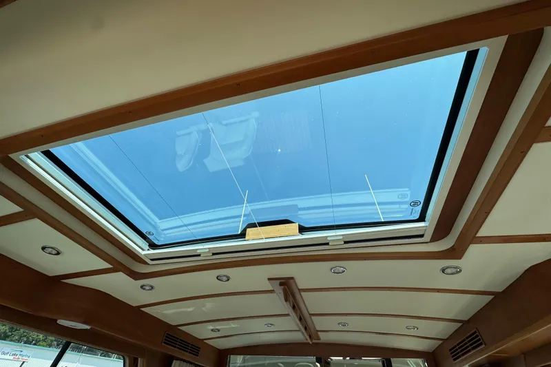 Moving On Yacht Photos Pics 2022 Sabre 48 Salon Express interior with skylight and wooden trim.