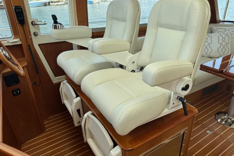 Moving On Yacht Photos Pics Luxurious interior of 2022 Sabre 48 Salon Express with plush white seating.