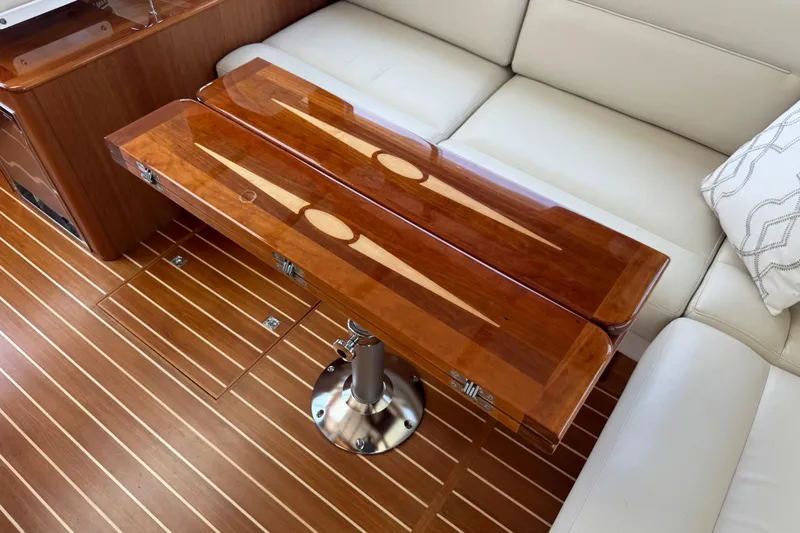 Moving On Yacht Photos Pics Luxurious interior of 2022 Sabre 48 Salon Express with elegant wooden table and seating.