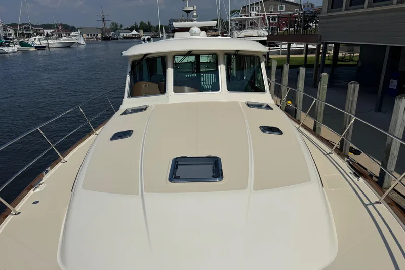 Moving On Yacht Photos Pics 2022 Sabre 48 Salon Express yacht docked at marina, showcasing sleek deck design.