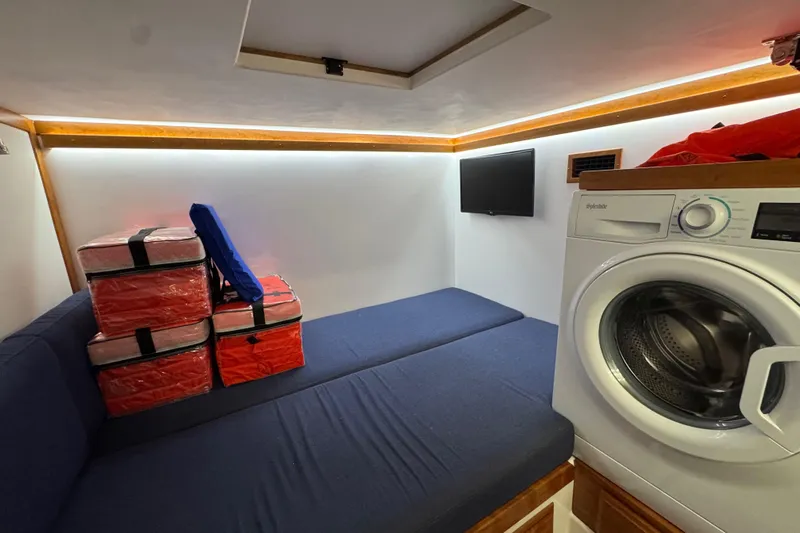 Moving On Yacht Photos Pics Interior of 2022 Sabre 48 Salon Express with seating, washer, and storage.