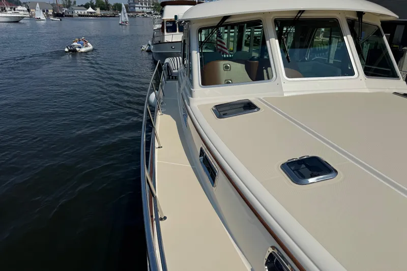 Moving On Yacht Photos Pics 2022 Sabre 48 Salon Express yacht docked in a marina, with scenic waterfront views.