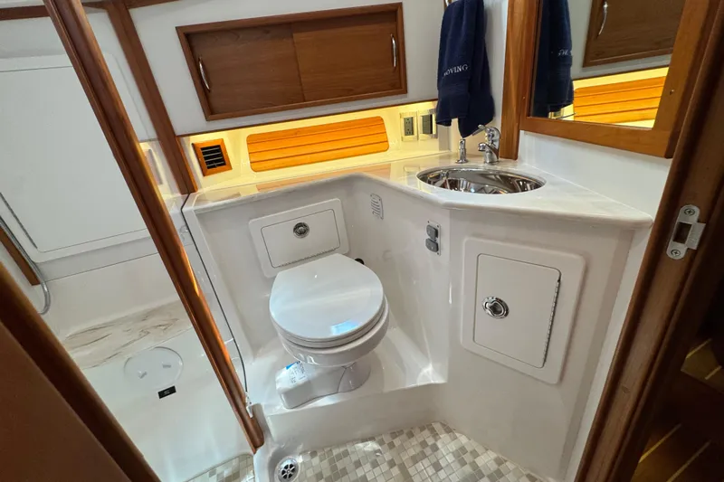Moving On Yacht Photos Pics 2022 Sabre 48 Salon Express bathroom with modern fixtures and wood accents.